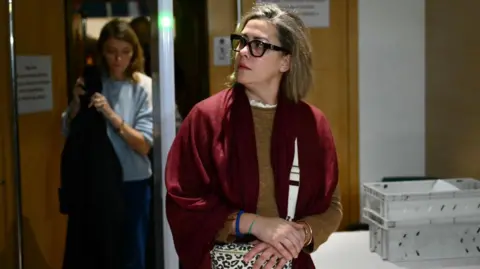 CHRISTOPHE SIMON/AFP Gisele Pelicot's daughter Caroline Darian gave evidence in court on Wednesday. Here she is leaving the court clasping her bag