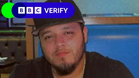 Reuters Kilmar Ábrego García wearing a black shirt and a black hat, with a BBC Verify logo in the top left corner
