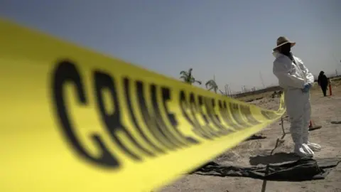 Reuters A forensic technician stands next to a cordoned area during a media tour by Jalisco’s Attorney General Office at Izaguirre Ranch, which activists have called a cartel-run "extermination camp," in Teuchitlan, Jalisco state, Mexico March 20, 2025.