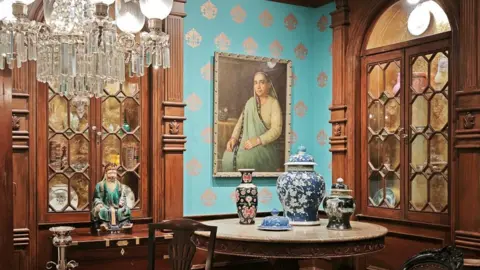 BBC A an exhibit displaying furniture, a portrait, vases and other items of famous Parsis at a newly renovated Parsi museum in Mumbai. 