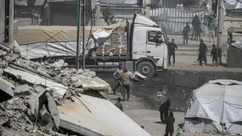 EPA A humanitarian aid truck drives along Al Rashid road into Gaza City, 25 May 2025