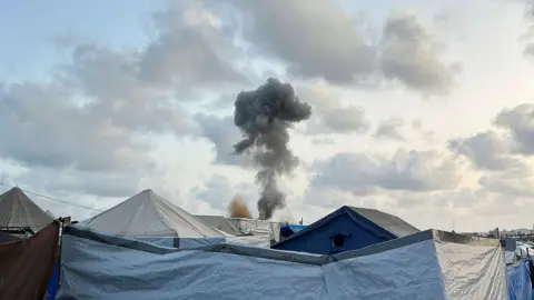 Reuters Smoke rises above tents sheltering displaced Palestinians, in Khan Younis, southern Gaza