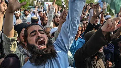 AFP via Getty Images Supporters of Jamiat Ulema-e-Islam Fazal (JUI-F) shout slogans during an anti-India protest in Islamabad on May 9, 2025.