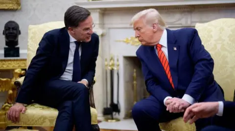 Getty Images Mark Rutte leans in to speak to Donald Trump in the Oval Office of the White House