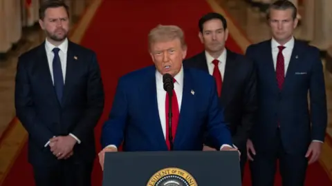 Getty Images Trump addresses the nation on Saturday night to inform them of the US air strikes on Iranian nuclear facilities, dressed in a blue suit and red tie and flanked by JD Vance, Marco Rubio and Pete Hegseth