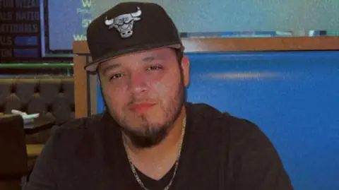 Reuters Man in black baseball hat