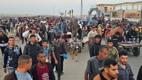 AFP Displaced Palestinians return from a food distribution centre in Rafah, in the southern Gaza Strip, on 1 June 2025