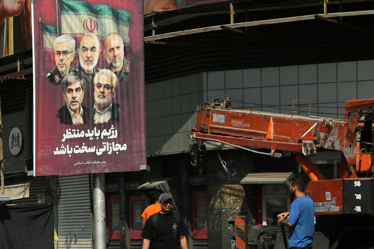 Posters featuring images of Iranian nuclear scientists Mohammad Mehdi Tehranchi and Fereydoun Abbasi-Davani, who were killed in Israeli attacks, as well as senior Islamic Revolutionary Guard Corps (IRGC) commanders Major General Hossein Salami, Major General Gholamali Rashid, Aerospace Force Commander Amir Ali Hajizadeh, and Major General Mohammad Bagheri, are put up on the streets of Tehran, Iran on June 14, 2025. Fatemeh Bahrami - Anadolu Agency]