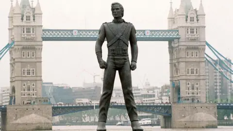 Getty Images A giant Michael Jackson statue appears to be stood on the River Thames in front of Tower Bridge.
