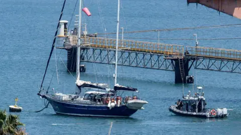 AFP An Israeli patrol boat near the Madleen yacht as it moored at the port of Ashdod in Israel on 10 June.