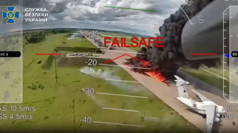 SBU A screengrab of some of the drone footage released by Ukrainian authorities on Wednesday showing a plane in flames at an airfield in Russia
