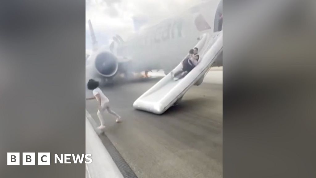 Passengers use emergency slides to flee plane fire at Denver airport
