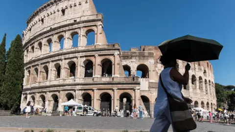 Getty Images Tourists visit the Colosseum as the heatwave is in progress in Rome, Italy.