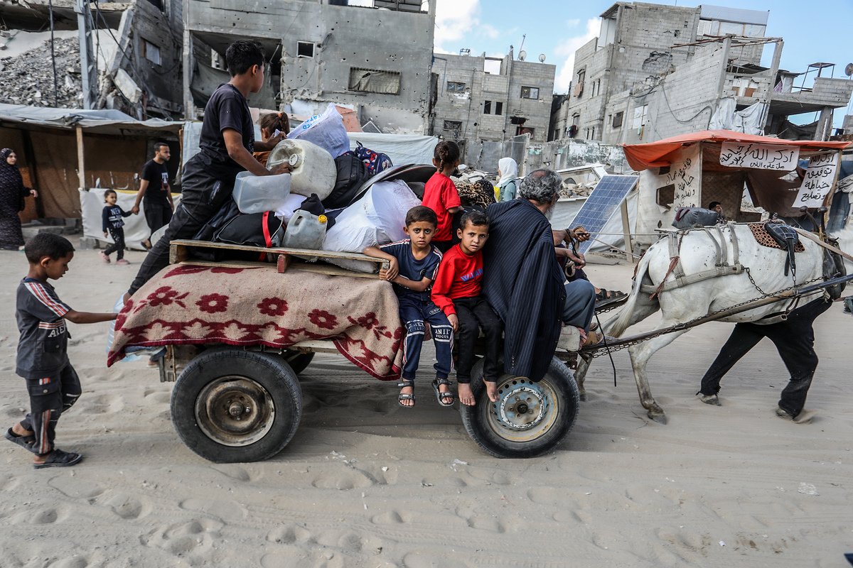 Palestinians are seen leaving their homes with belongings in hand, using horse carts, vehicles, or traveling on foot in search of safer areas following urgent evacuation warnings issued by the Israeli military in Khan Yunis, Gaza, on June 03, 2025. [Abed Rahim Khatib - Anadolu Agency]