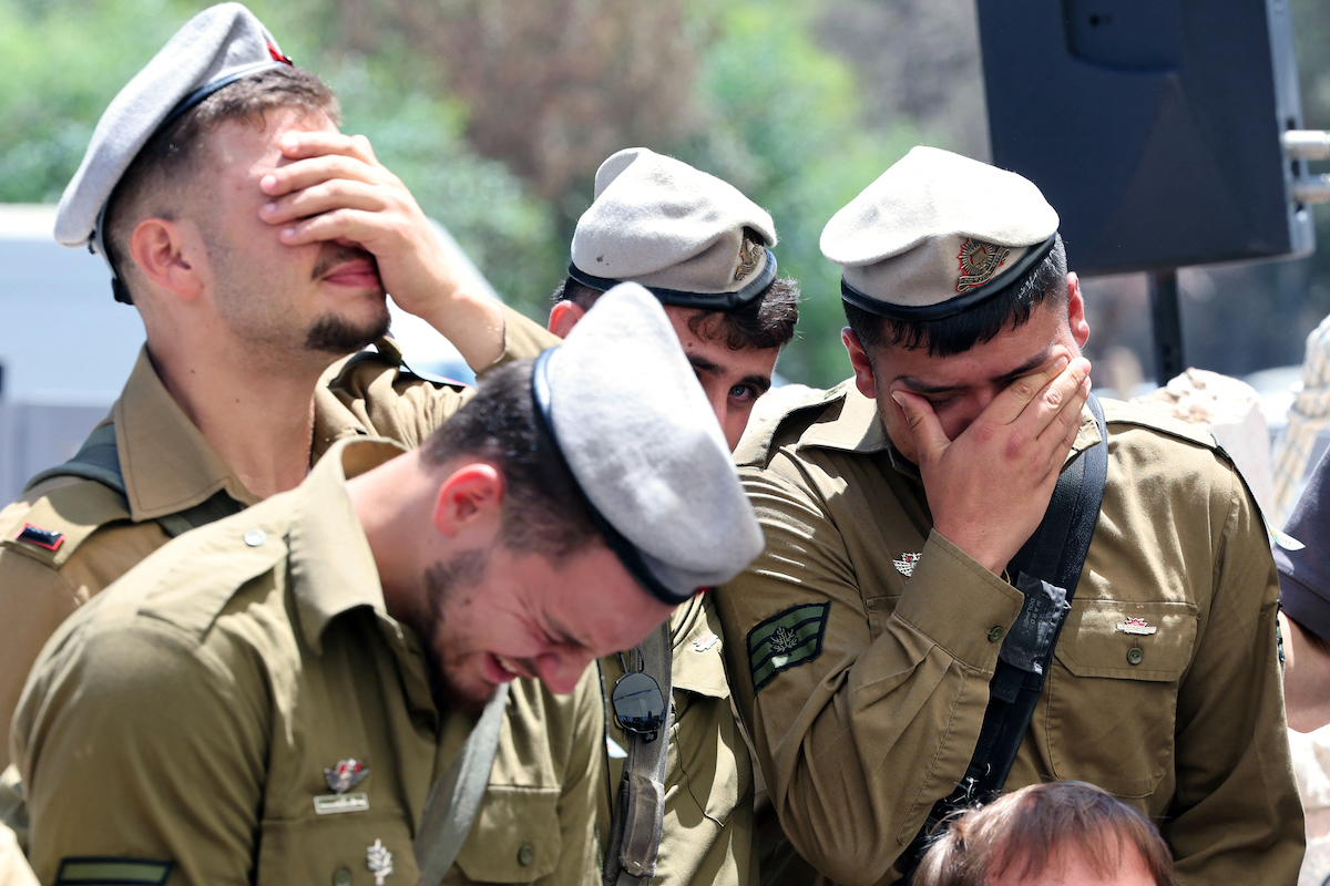 Israeli soldiers cry during the funeral of Matan Yashinovaki, 21, a soldier killed in the Gaza Strip, in Kfar Yona on June 26, 2025. [JACK GUEZ / AFP/ Getty Images]