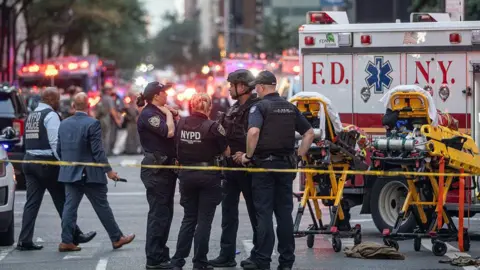 Getty Images Police stand outside 345 Park Avenue after a shooting