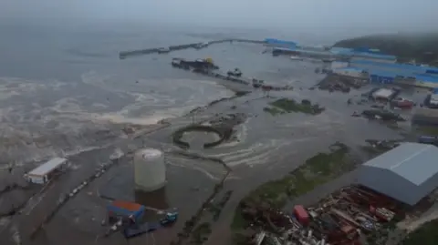 Reuters Tsunami waves flood an area after a powerful magnitude 8.8 earthquake struck off Russia's far eastern Kamchatka Peninsula, in Severo-Kurilsk, Sakhalin Region, Russia, July 30, 2025.
