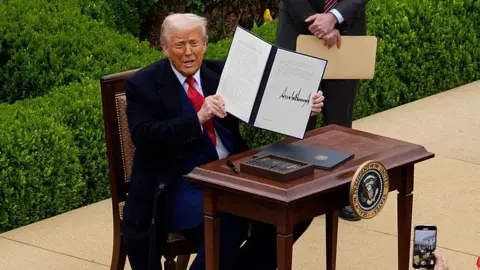 Getty Images US President Donald Trump announces tariffs at the White House in April