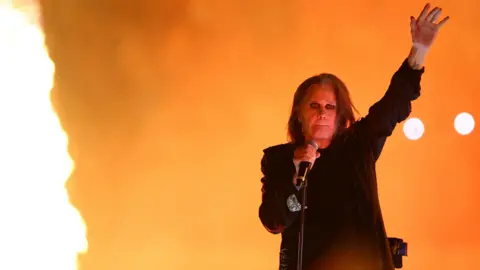Reuters Ozzy Osbourne performs on stage, next to fire