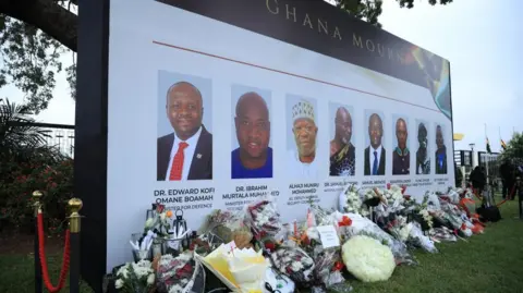 EPA Tributes and flowers placed at a mourning site for eight people, including two government officials, who died in a military helicopter crash