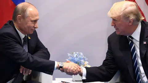 Getty Images US President Donald Trump and his Russian counterpart Vladimir Putin shake hands