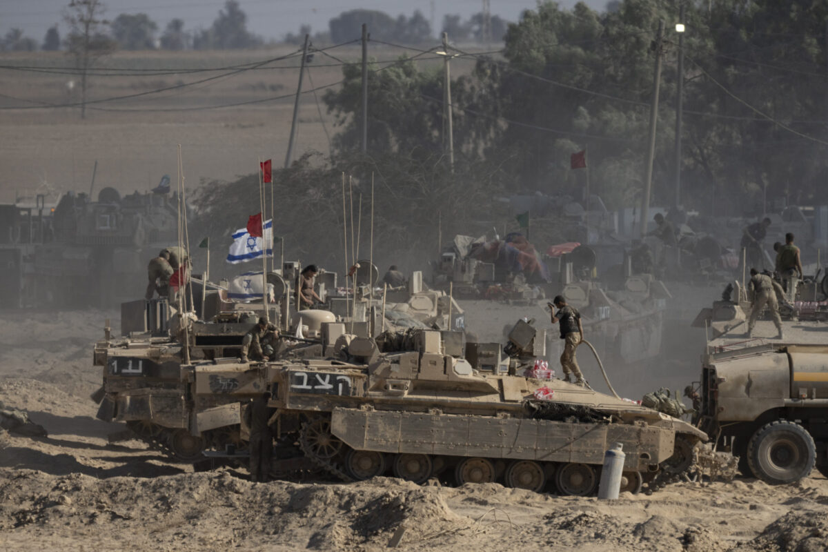 Israeli soldiers organize military equipment while standing on armored personnel carriers near the border with the Gaza Strip on August 6, 2025 in Southern Israel, Israel. [Amir Levy/Getty Images]