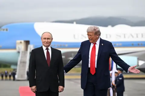 EPA Donald Trump welcomes Vladimir Putin to Alaska with a red carpet and a warm handshake.