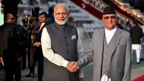 Getty Images Modi seen shaking hands with KP Sharma Oli after receiving the guard of honour in Army Pavilion, Kathmandu, Nepal on 11 May, 2018
