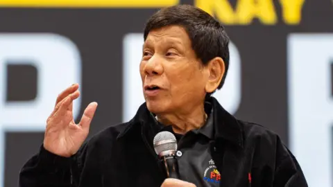 Getty Images Former Philippine President Rodrigo Duterte gives a speech during a campaign rally at Southorn Stadium on March 09, 2025 in Hong Kong
