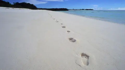 LightRocket via Getty Images Footprints on a white sand beach, on Assumption Island in the Seychelles.