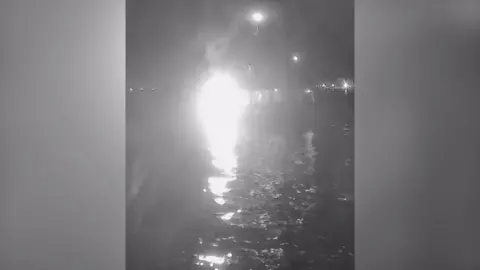 GLOBAL SUDUM FLOTILLA A bright white light which looks like an explosion is seen in a video purporting to show a boat being hit by a flaming object