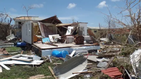 Getty Images A home on the Caribbean island of Barbuda that had been torn apart by the high winds generated by Hurricane Irma in 2017