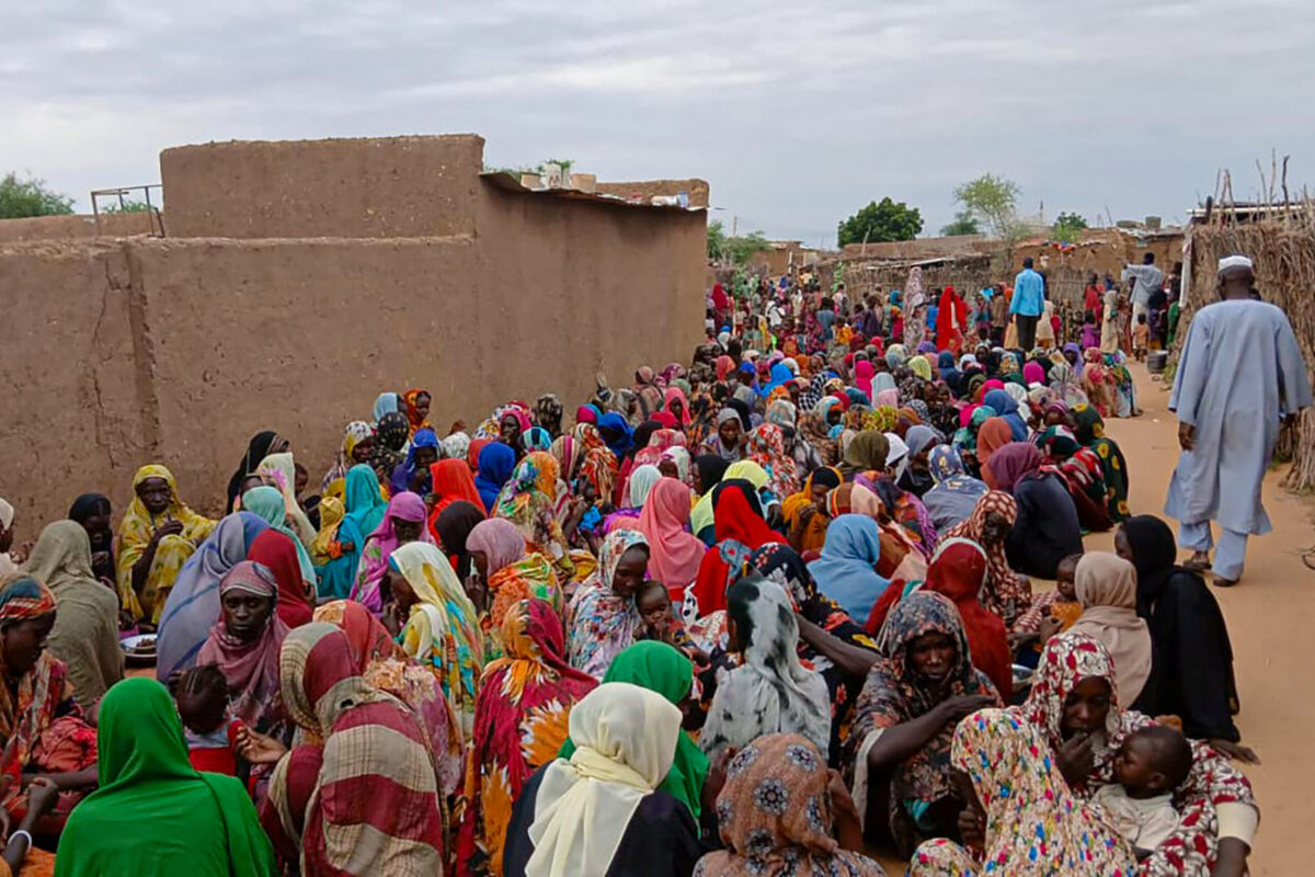 Sudanese residents gather to receive free meals in Al Fasher, a city besieged by Sudan's paramilitary Rapid Support Forces (RSF) for more than a year, in Darfur region, on August 11, 2025. [AFP via Getty Images]