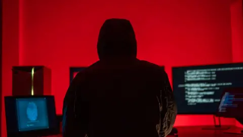 Getty Images Hackers work secretly in secret rooms. Mysterious colored lights Breaking into personal security and various agencies in the world . Wanted Hacker using computer for hacking in the cyber data center .