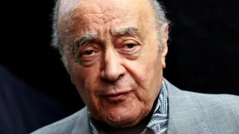 Reuters Mohamed Al Fayed in a grey suit jacket and a patterned monochrome shirt