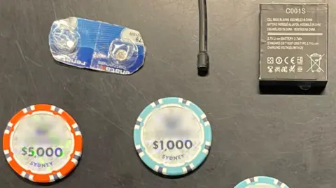 NSW Police A hidden camera, batteries and casino chips photographed as evidence.