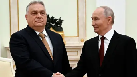 EPA Russian President Vladimir Putin (R) and Hungarian Prime Minister Viktor Orban shake hands during a meeting at the Kremlin in Moscow, Russia, 28 November 2025.