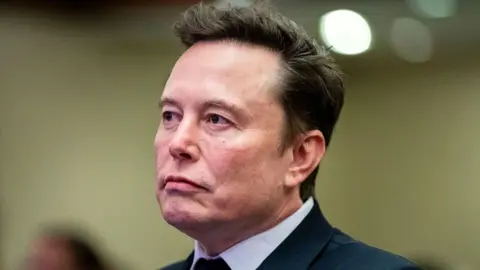 AFP via Getty Images Elon Musk in a suit