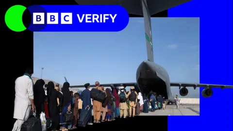 US Air Forces Europe-Africa via Getty Images Verify logo placed over a photograph of Afghan evacuees queuing to board US military aircraft following the fall of Kabul in 2021. 