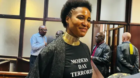 Supplied Duduzile Zuma-Sambudla is seen wearing a black shirt branded "Modern day terrorist"