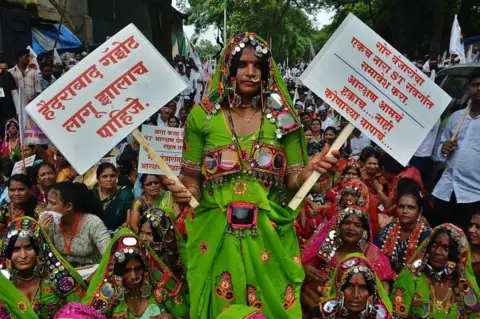 Praful Gangurde/Hindustan Times via Getty Images Members of the Banjara community from across Maharashtra gathered in Thane on Saturday to press their key demands implementation of the Hyderabad Gazette and inclusion of the community in the Scheduled Tribes (ST) category to secure reservation benefits, on October 4, 2025 in Mumbai, India. Thousands of community members participated in the morcha, raising slogans as they marched through major roads of the city before reaching the District Collector's office. The protesters urged the government to take an immediate and positive decision to ensure justice for the Banjara community. (Photo by Praful Gangurde/Hindustan Times via Getty Images)
