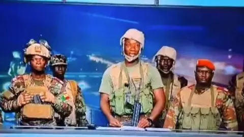 BTV Benin soldiers dressed in army uniform appearing on national tv to announce suspension of the country’s constitution.