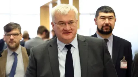 Reuters Ukrainian Foreign Minister Andrii Sybiha walks after attending a working lunch of the NATO-Ukraine Council, at the NATO headquarters in Brussels,