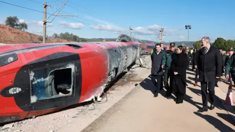 Reuters Spain's King Felipe and Queen Letizia visit the site of the deadly derailment of two high-speed trains near Adamuz, in Cordoba, Spain, January 20, 2026