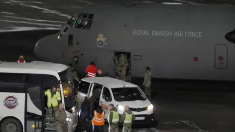 Reuters A plane with the Royal Danish Air Force livery stands on the tarmac at Nuuk airport