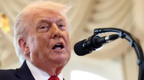 REUTERS/Kevin Lamarque US President Donald Trump speaks at a ceremony held to dedicate a 4-mile stretch of road from West Palm Beach Airport to his Mar-a-Lago estate as 'President Donald J. Trump Boulevard', at the Mar-a-Lago estate in Palm Beach, Florida, U.S., January 16, 2026. 
