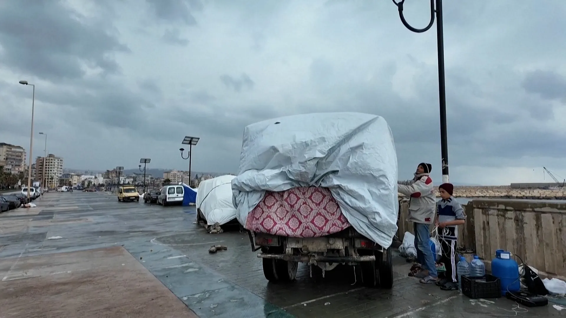 Displaced families in Lebanon turn vehicles into rain-soaked shelters | Hezbollah