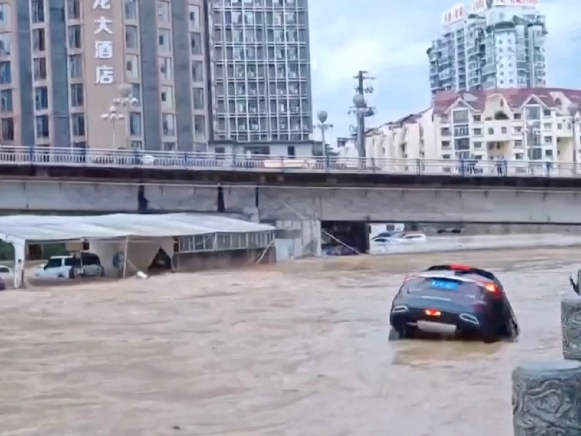 Flooding in southern China washes away cars and destroys bridge | News